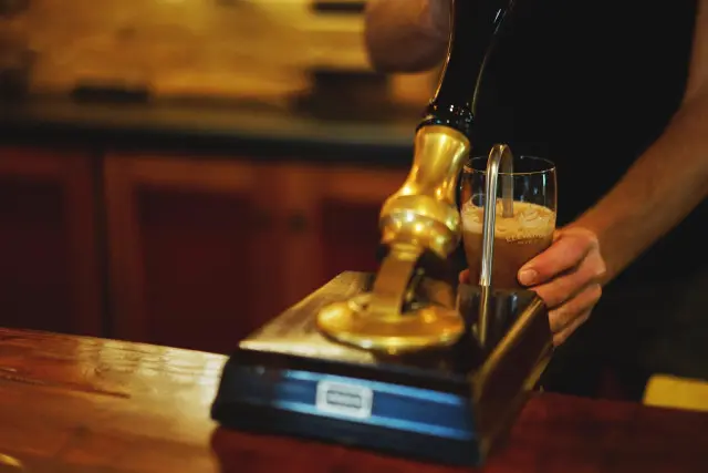 Beer pump filling a glass of beer